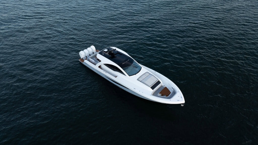 Aerial view of a white sport motor yacht under way on deep blue water