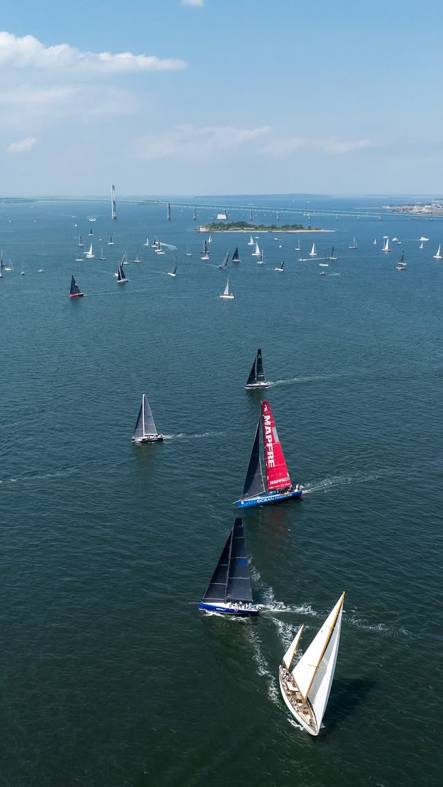 Aerial view of a racing yacht sailing through a crowded regatta fleet on Narragansett Bay