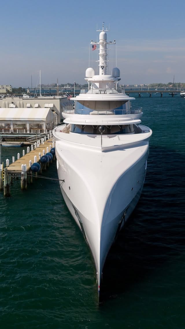 Large white motor yacht berthed bow-on at a dock in Newport, Rhode Island