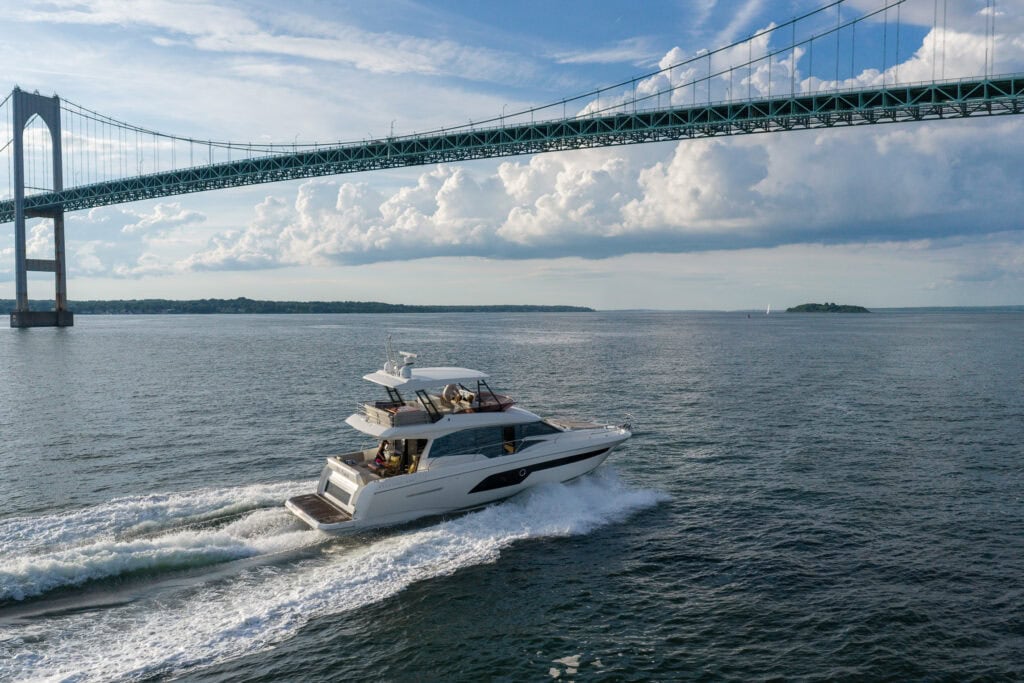 Motor yacht arriving in Newport, Rhode Island, passing the Claiborne Pell Newport Bridge at the end of a delivery