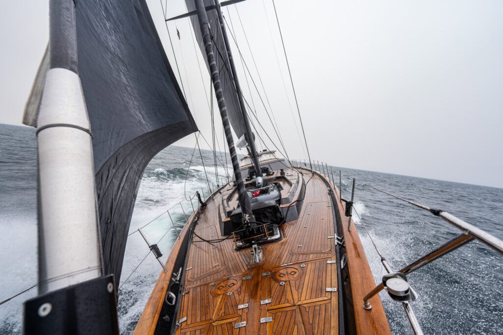 Teak foredeck of a sailing yacht under way offshore during a New England yacht delivery