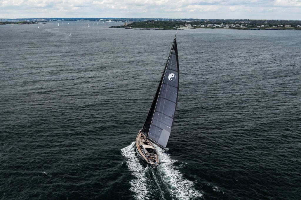Aerial view of a sailing yacht under way along the Newport, Rhode Island coastline during a delivery