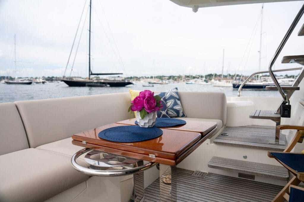 Cockpit dining table set with flowers aboard the motor yacht At Eaze