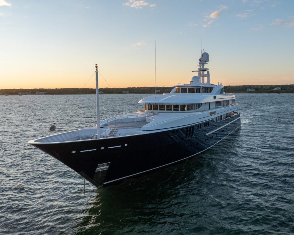 Navy-hulled superyacht at anchor at dusk off Martha's Vineyard