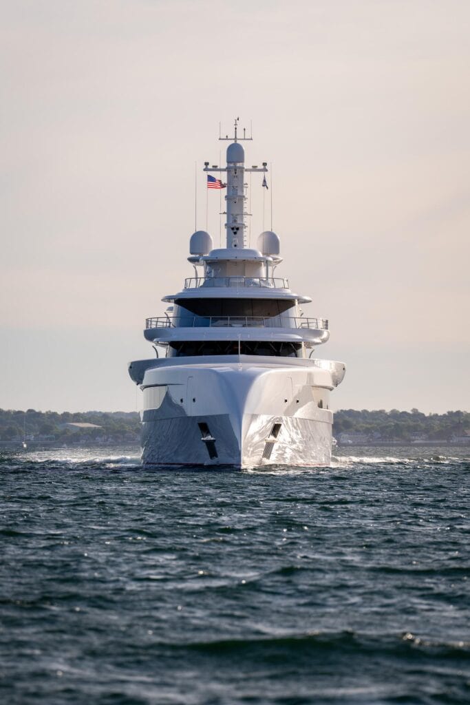 Modern superyacht under way bow-on off Newport, Rhode Island