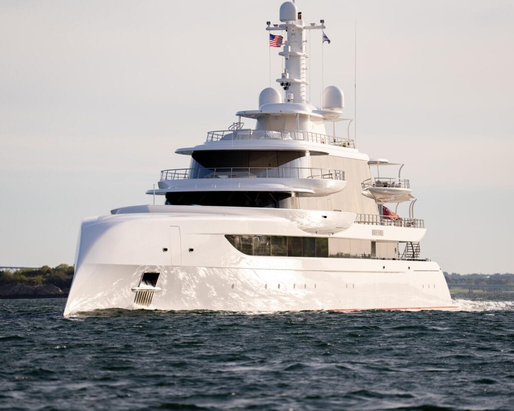 Modern white superyacht under way along the Newport coastline