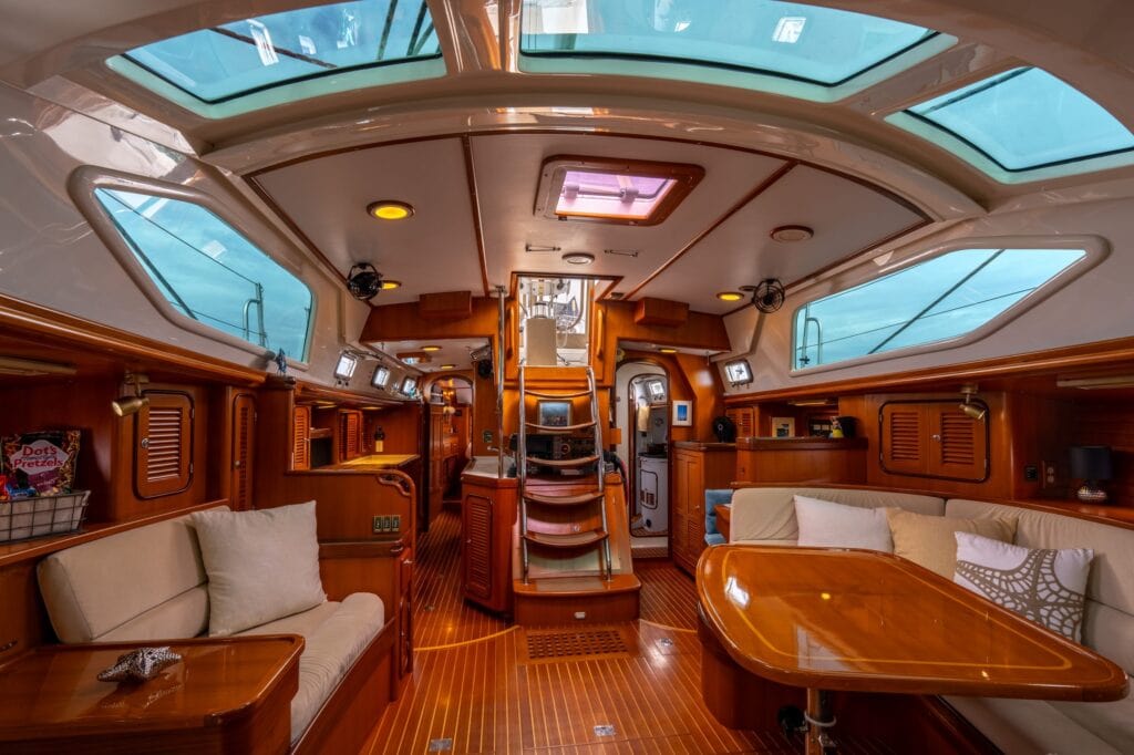 Varnished teak saloon and companionway aboard the sailing yacht Rubycon