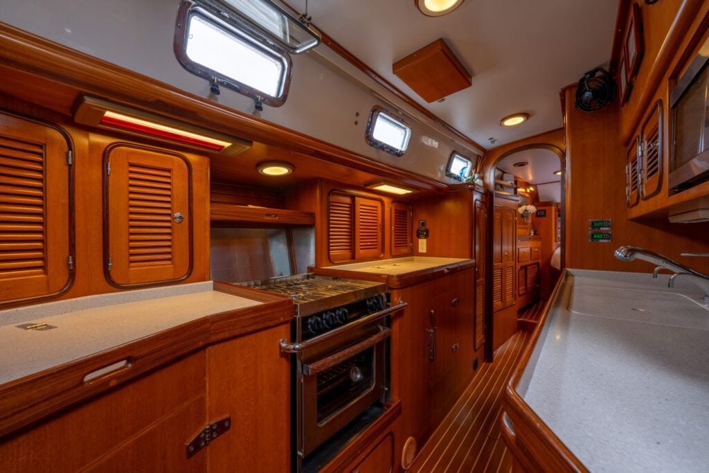 Galley with stove and teak joinery aboard the sailing yacht Rubycon